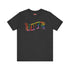 Election 2024 t-shirt with "VOTE" printed in large, colorful letters. Each letter features a different color from the rainbow spectrum, styled in a groovy 70s-inspired font.